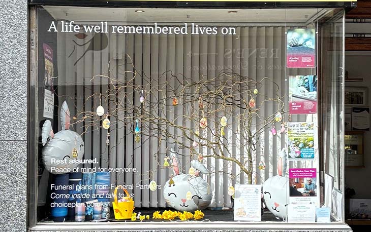 Front of the branch window decorated in an Easter theme with bunny balloon.